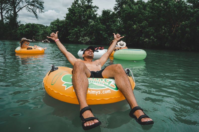 Guy floating on the san marcos river
