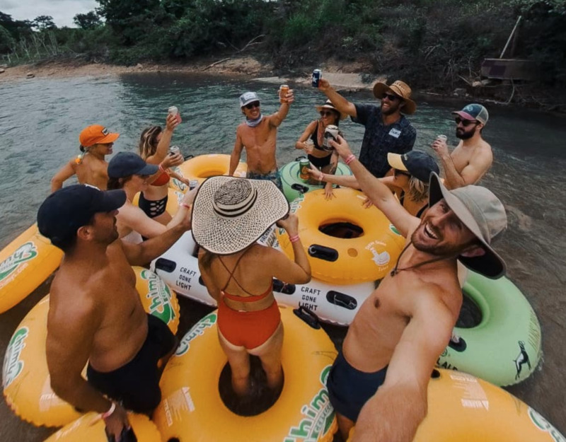 Company outing team cheers on the river